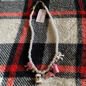 This is a Betsy Johnson charm necklace with white pearls!
